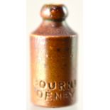 MINIATURE GINGER BEER BOTTLE. 7/8ins tall, st. shape, all tan glaze impressed BOURNE/ DENBY. Very