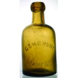 STAMFORD DUMPY SELTZER BOTTLE. 6.25ins tall, golden amber glass, acid etched lettering G & H.R.