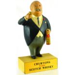 CHURTONS SCOTCH WHISKY ADVERTISING FIGURE. 10.25ins tall, rubberoid portly gent bottle & glass in