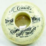 BELFAST MCCONNELLS IRISH WHISKY MATCHSTRIKER. 4.25ins diam, off white glaze, donut shaped.