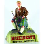 MACKINLAYS WHISKY BREWERY FIGURE. 7.5ins tall, multicoloured rubberoid figure of Scottish kilted