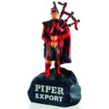 PIPER EXPORT BACK BAR FIGURE. 6.5ins tall, rubberoid figure of Scotsmanin tartans, playing bag