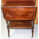 A 19th century rosewood and inlaid two tier drop flap table.