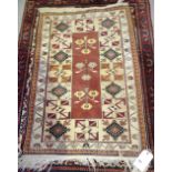 A cream ground small rug with three floral medallions, 76cm x 115cm.