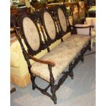 A 19th century oak triple seat show frame sofa with upholstered back and seat.