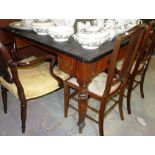 A Victorian mahogany dining table, with a black carved top.