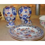 A pair of Chinese Imari lidded vases and two Imari plates.