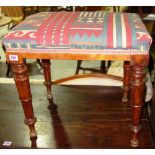 A 19th century mahogany stool with kilim type upholstery.
