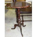 A 19th century walnut inlaid tripod occasional table.