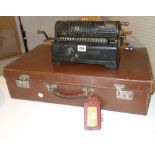 A 20th century brown leather suitcase, containing photographic items and a mechanical calculator.