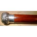 A silver topped walking cane.