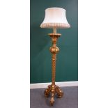 A carved giltwood standard lamp, within blind fret decoration,
