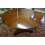 A George III style mahogany circular centre table, on octagonal column and triform platform,