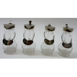 A group of four silver mounted and glass whisky noggins,