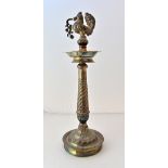 An ornamental stand, formed as a column with an exotic bird surmount, on a circular base,