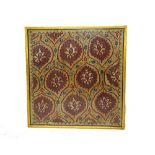 A Bokhara Susani panel, framed, the field embroidered with madder lozenges each bearing a flower,