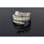 A white gold and diamond set ring, in a serpentine design,