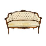 A diminutive Victorian carved walnut show frame sofa with button upholstery, 125cm wide x 84cm high.