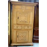 A large 19th century North European painted cupboard/armoire, with floral carved doors,