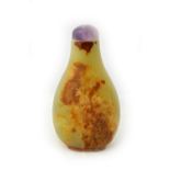 A Chinese yellowish celadon and russet jade snuff bottle, of pear form,