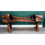 A 20th century naturalistic dug out bench, 175cm wide x 85cm high.