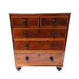 An early 19th century diminutive mahogany chest of two short and three long graduated drawers,