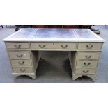 A grey painted 18th century style pedestal desk, with eight drawers about the knee,