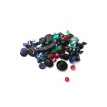 A collection of unmounted coloured gemstones, including; a synthetic corundum imitating alexandrite,