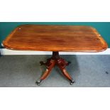 A Regency breakfront table, the crossbanded mahogany rectangular top on four downswept supports,