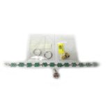A white gold and emerald set cluster link bracelet, (one emerald detached and present,