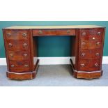 A late Victorian mahogany kneehole writing desk with serpentine pedestals, 134cm wide x 74cm high.