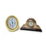 A Cartier Paris gilt metal and cream lacquer mounted oval strut backed alarm clock,
