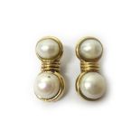 A pair of 9ct gold and cultured pearl earclips, each mounted with two freshwater cultured pearls,