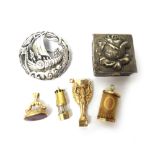 Four 9ct gold charms, comprising; The World Cup, a miner's lamp,