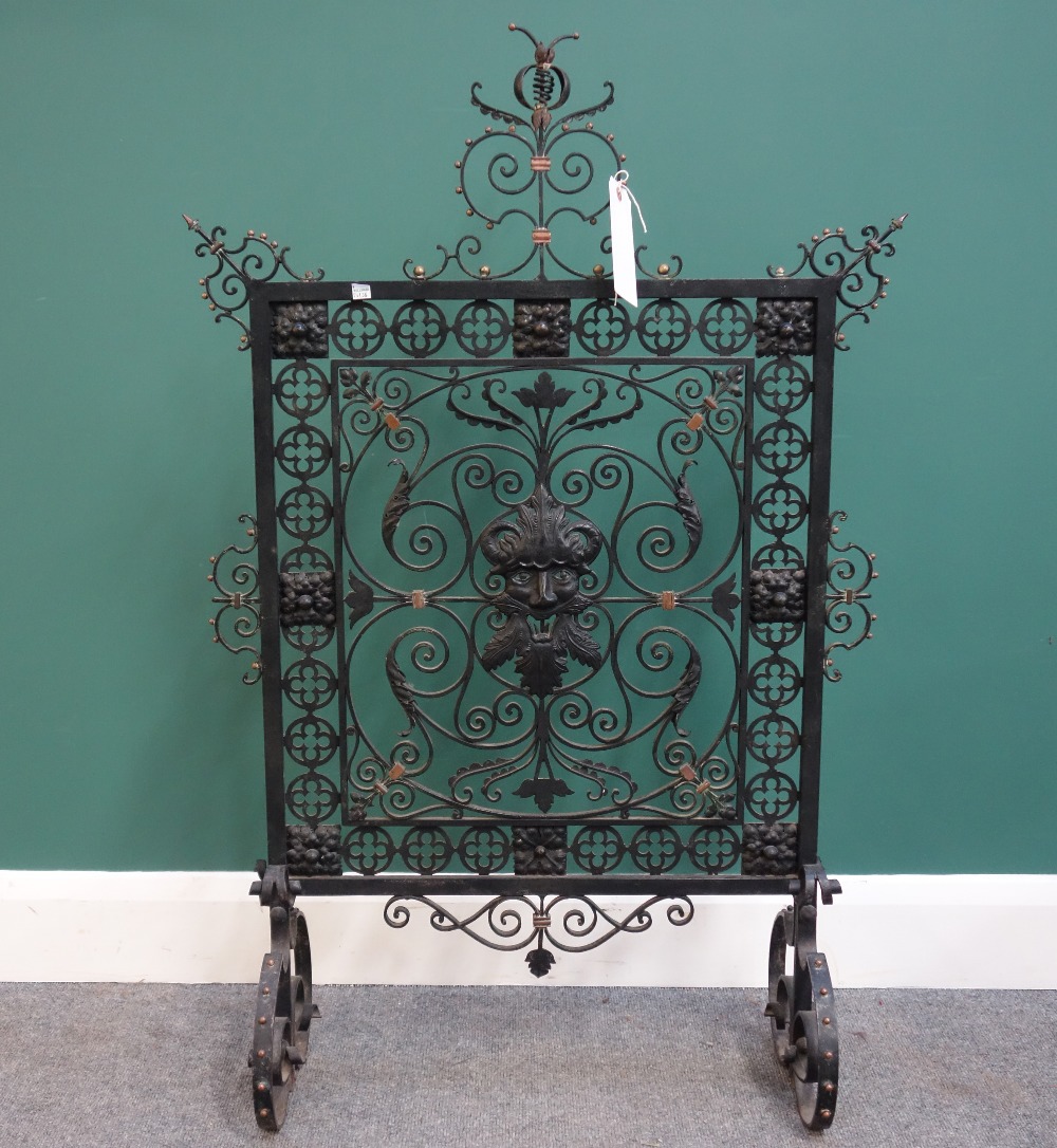 A late 19th century wrought iron, brass and copper fire screen in the Renaissance revival taste,