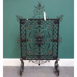 A late 19th century wrought iron, brass and copper fire screen in the Renaissance revival taste,