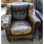 An early 20th century brown leather upholstered wingback armchair, 86cm wide x 88cm high.