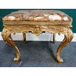 A Louis XV style carved gilt framed rectangular footstool, 55cm wide x 51cm high.