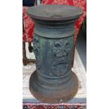 A Victorian cast iron pedestal of conical form, relief cast with masks, 48cm wide x 81cm high.