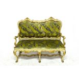 An 18th century North Italian cream and parcel gilt painted sofa, with shaped padded back and seat,