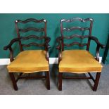 A pair of George II style mahogany wavy ladder back carver chairs, on block supports,