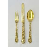 A Victorian silver gilt three piece christening set, comprising; a knife, having a loaded handle,