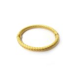 A gold oval hinged bangle, in a decorated ropetwist design, detailed 750,