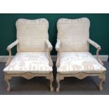 A pair of cream painted open armchairs in the Louis XV style, 95cm high x 72cm wide.