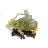 A Chinese celadon jade group of a boy on a water buffalo, 19th/20th century,