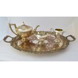 A silver three piece tea set, comprising; a teapot, a twin handled sugar bowl and a milk jug,