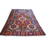 A Bakhtiari carpet, Persian, the trellis field filled with flowers, trees and birds,