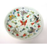 A Chinese famille-rose dish, red six character Guangxu mark, painted with scattered butterflies,