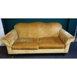 Wesley-Barrell; a 20th century gold upholstered humpback sofa, on turned supports,