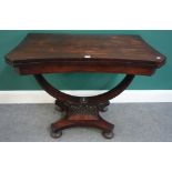 An early 19th century rosewood card table, with concave top and open elliptic support,